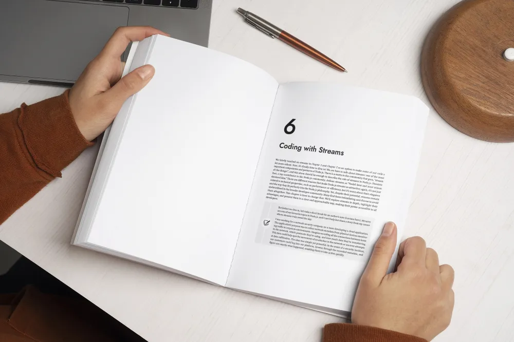 Open Node.js Design Patterns book on a desk, showing Chapter 6 “Coding with Streams.”